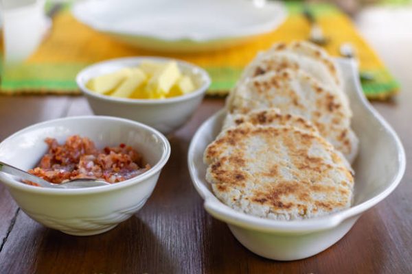 Traditional sri lankan coconut pol roti flat bread with butter and lunu miris dip from red onion and chilli